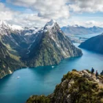 Best places to visit in New Zealand featuring Queenstown's Lake Wakatipu, Milford Sound fjord, Rotorua geothermal park, and Auckland Sky Tower collage